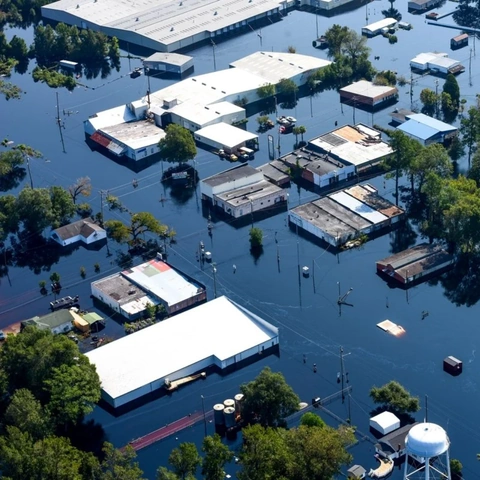 Aerial view of an industrial estate inundated by flood waters, illustrating the kind of physical climate exposure RedLines assesses