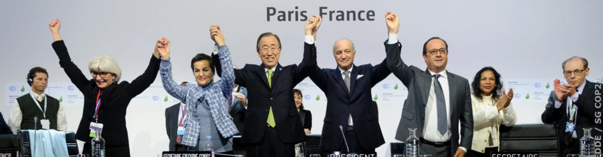 Multiple world leaders hand in hand celebrating the Paris Agreements in 2016