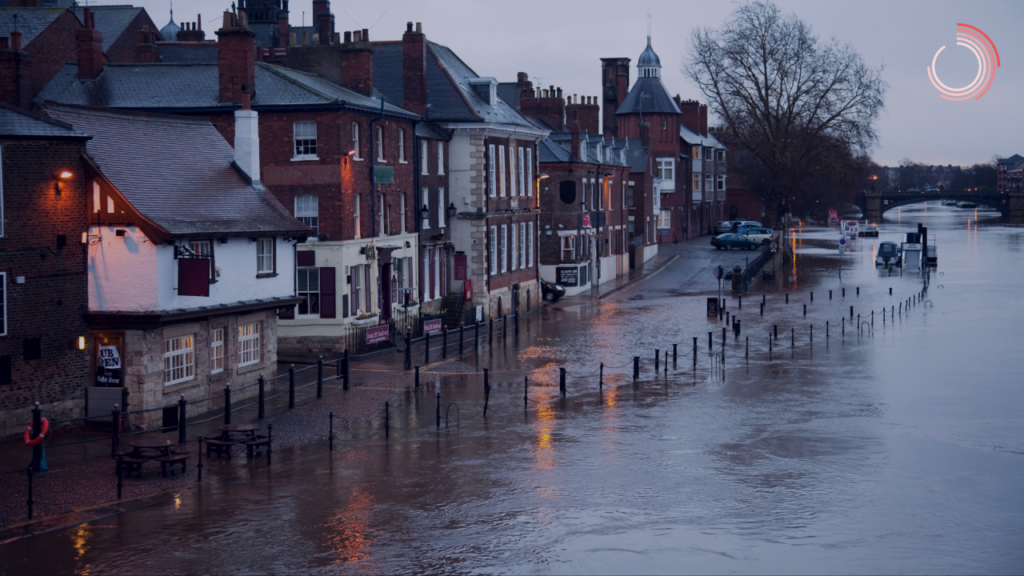 Flooded English street, with pubs and vehicles looked stranded from the river which has burst it's banks.